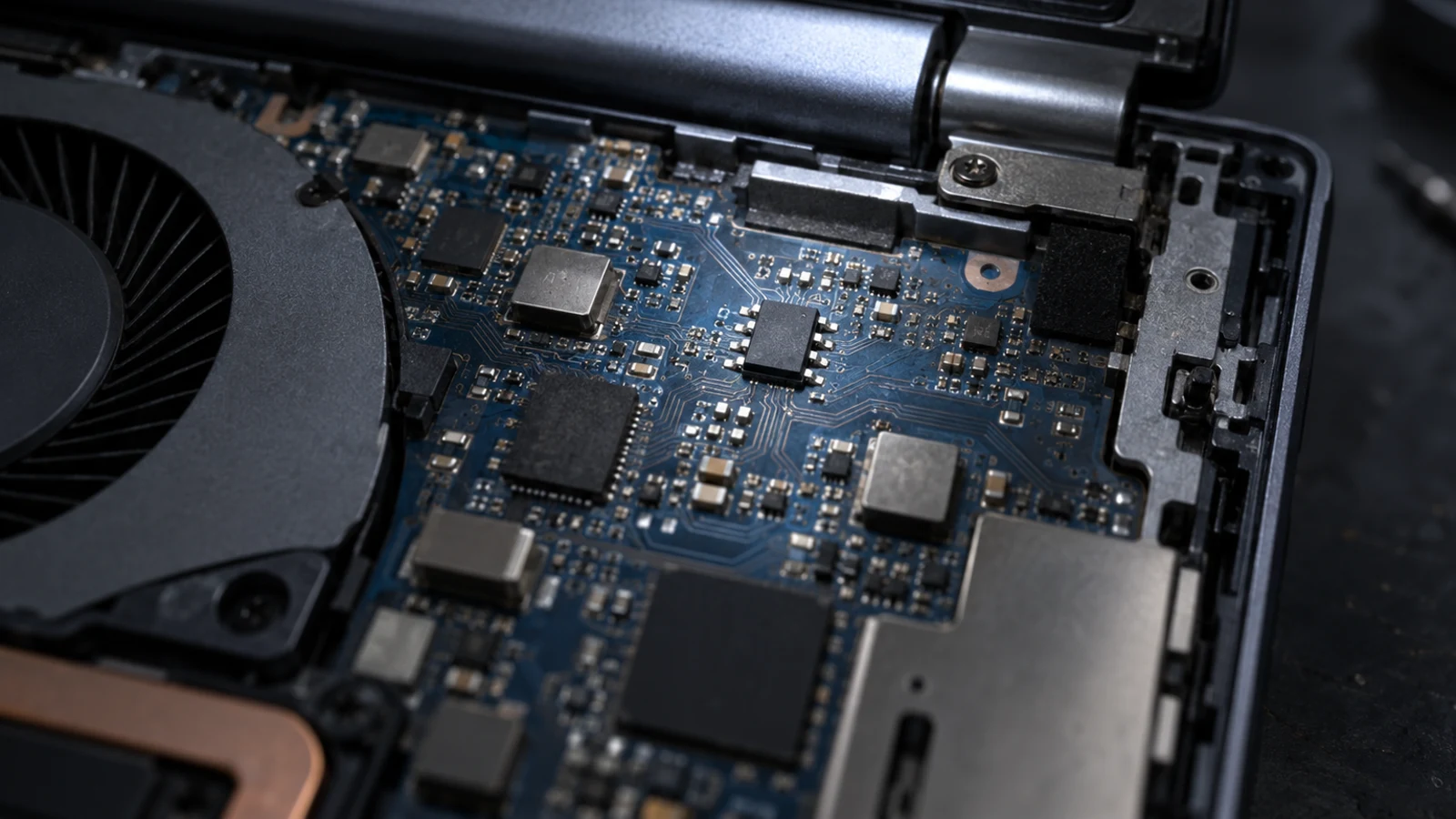 Close view of a laptop motherboard with several chips and circuit traces.